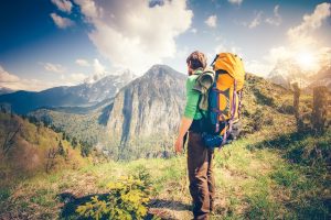 Young Man Traveler with backpack relaxing outdoor